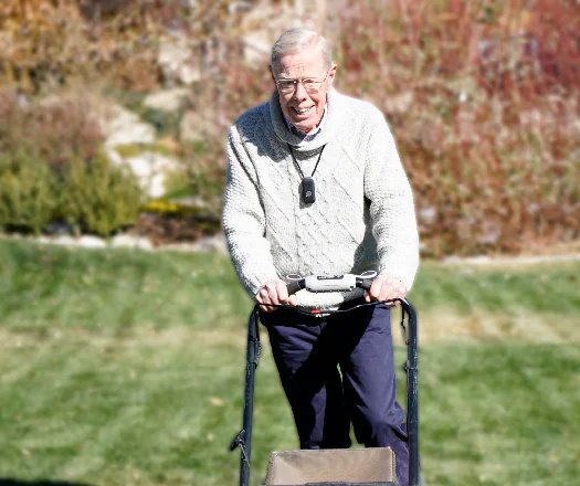 Safety Alert Center customer wearing a medical alert device while outdoors